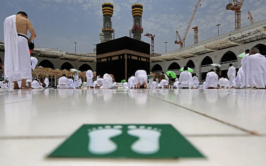 Muslim worshippers pray around the Kaaba, the holiest shrine in the Grand mosque complex in the Saudi city of Mecca, during the Friday prayers of the Muslim holy fasting month of Ramadan, on April 16, 2021. (AFP)