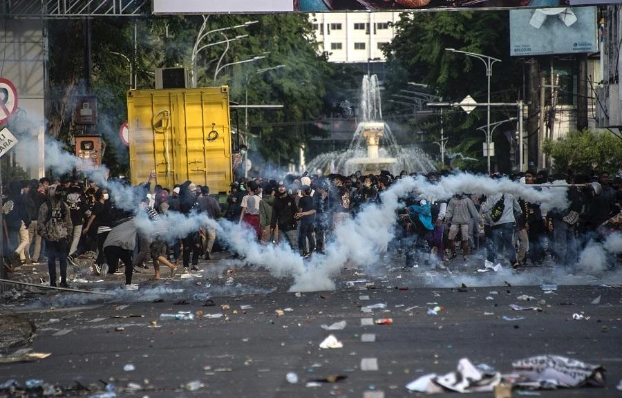 Police fire teargas at activists during clashes amid a nationwide strike against a controversial new law which critics fear will favour investors at the expense of labour rights and the environment, in Surabaya on October 8, 2020. (File/AFP)