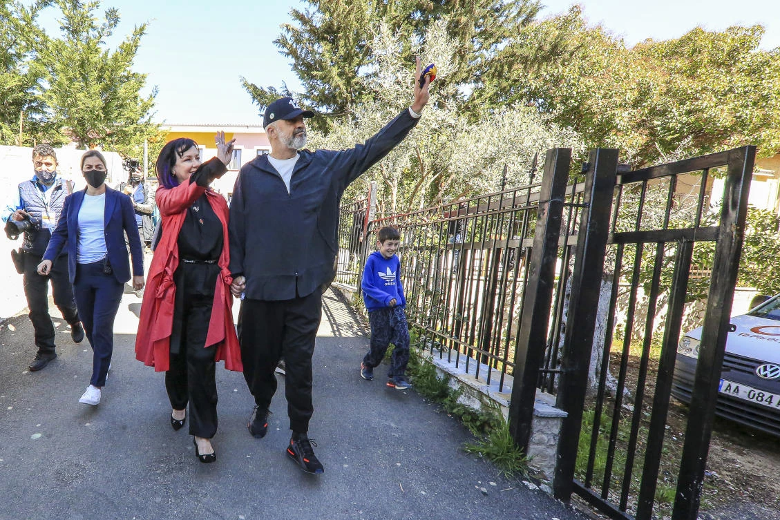 Albania’s socialist party leader Edi Rama and wife Linda Rama wave to supporters as they leave a voting station in Surel, near Tirana, Sunday, April 25, 2021. (AP Photo)