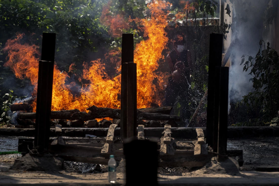 A man cleans a cremation platform to burn a body of a person who died of COVID-19 in Gauhati, India on April 27, 2021. (AP)