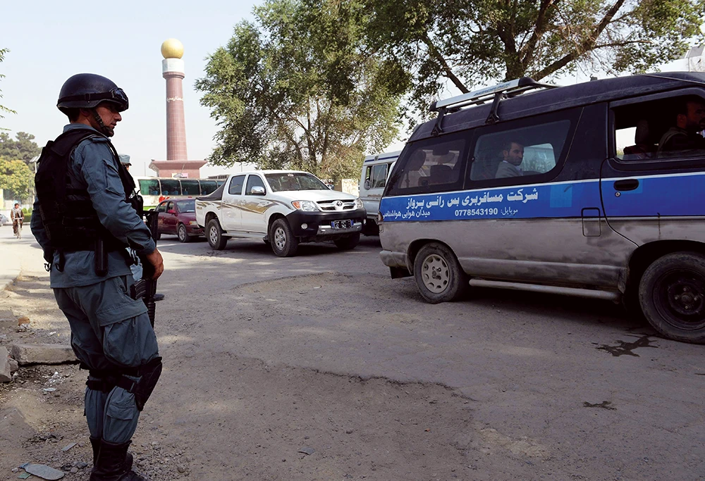 An Afghan cop keeps watch at a check post near the US Embassy in Kabul. (AFP)