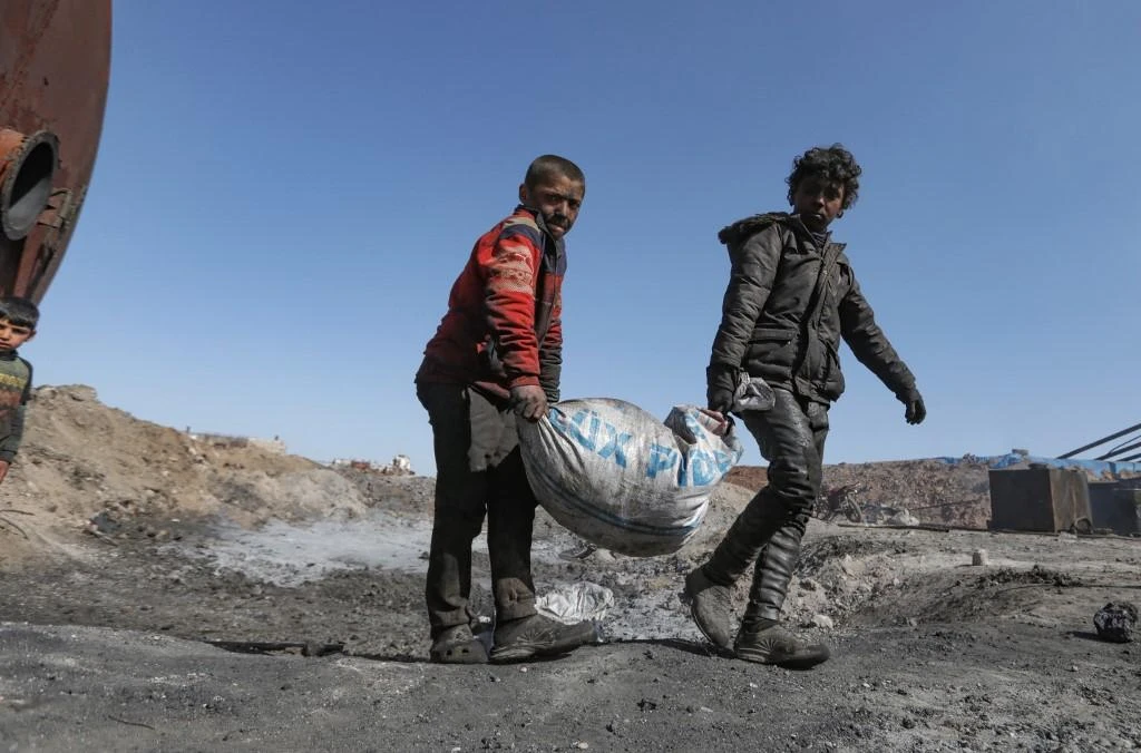 Displaced young Syrian boys work at a makeshift oil refinery in the northern countryside of Aleppo. (File/AFP)