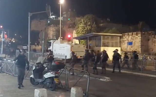 Israeli riot police deploy water cannon during clashes with Palestinians close to the Damascus Gate on Sunday, April 18, 2021. (Screengrab: Twitter)