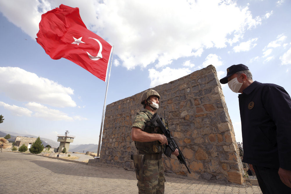 Turkish Defense Minister Hulusi Akar visits Turkish troops at the border with Iraq in Hakkari province on June 19, 2020. (AP Photo)