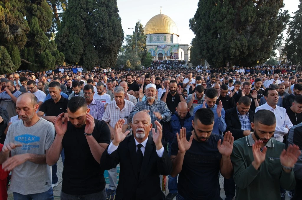 Muslims perform the morning Eid Al-Fitr prayer outside the Dome of the Rock mosque in the Al-Aqsa mosques compound in Old Jerusalem early on May 13, 2021. (AFP)