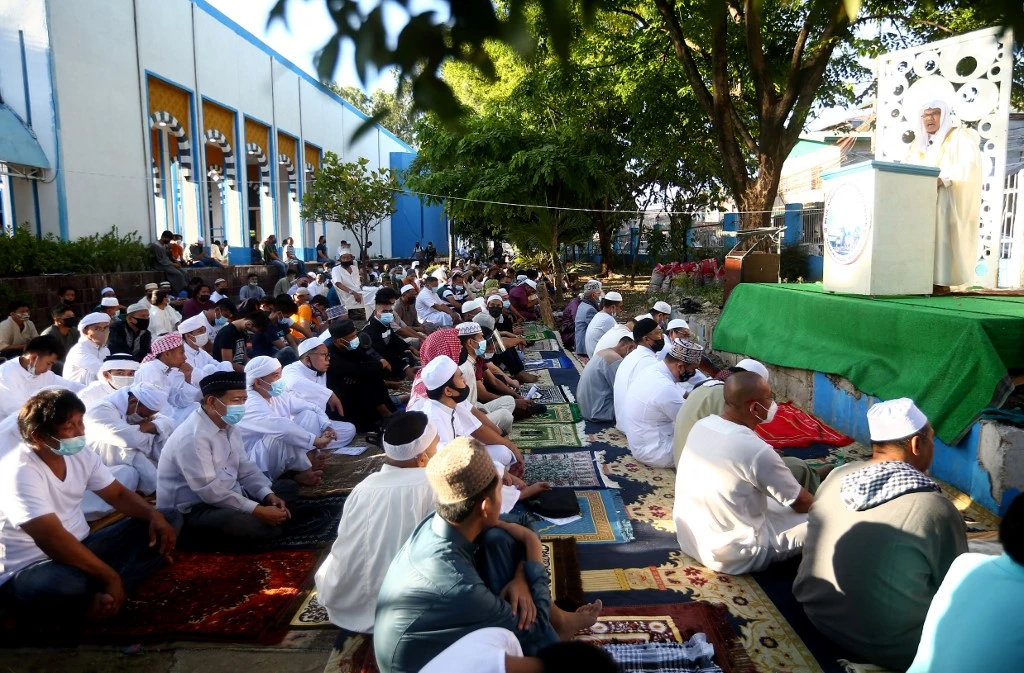 Muslims listen to an Imam at a mosque during Eid Al-Fitr celebrations in Manila on May 13, 2021. (AFP)