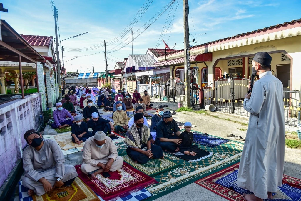 Muslims perform the morning Eid Al-Fitr prayer on the street as authorities closed mosques to prevent the spread of coronavirus in Thailand's southern province of Narathiwat on May 13, 2021. (AFP)
