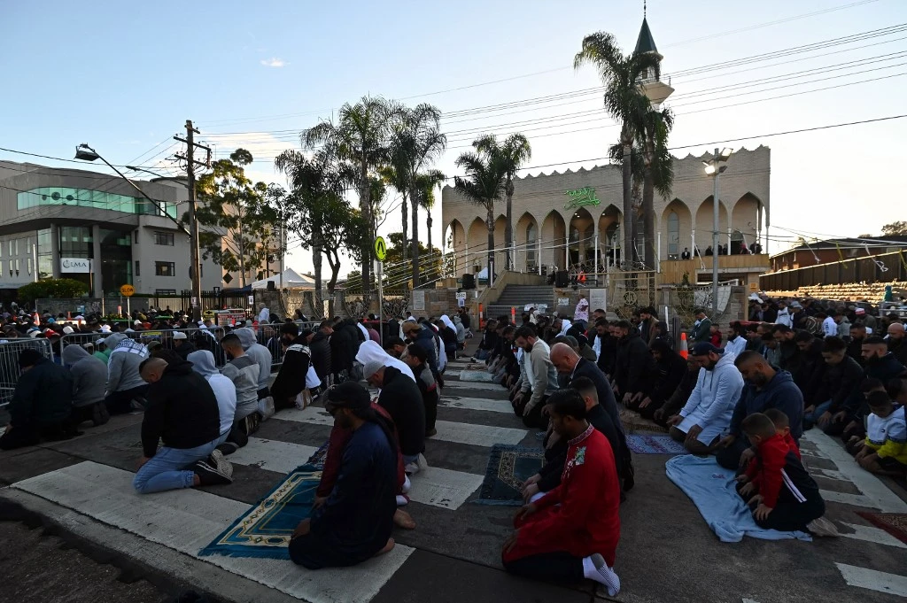 Muslims take to the street to participate in Eid Al-Fitr prayer at the Lakemba Mosque in Sydney on May 13, 2021. (AFP)