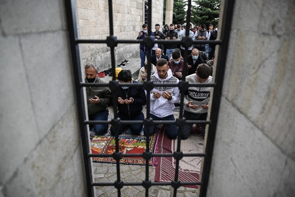 People take part in Eid Al-Fitr prayer on May 13, 2021 at the Grand Mosque in Pristina, Kosovo. (AFP)