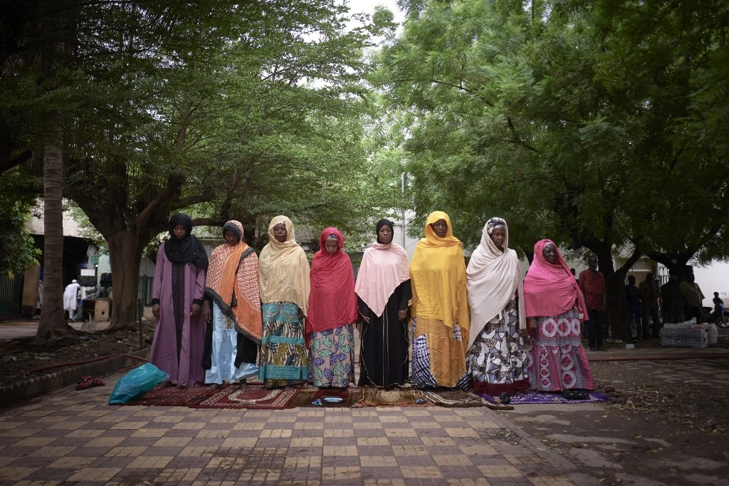 A group of women praying in the courtyard of the Roi Faycal Bin Abdoulaziz Mosque during Eid Al-Fitr in Bamako on May 12, 2021. (AFP)