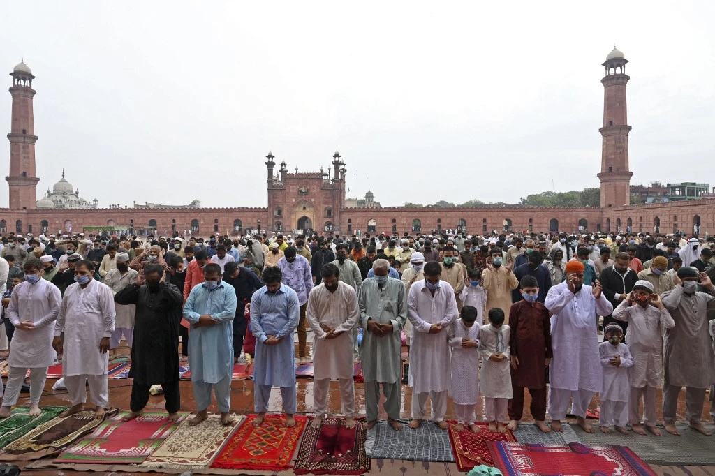 Muslims perform Eid Al-Fitr prayer at the historic Badshahi Mosque in Lahore on May 13, 2021. (AFP)