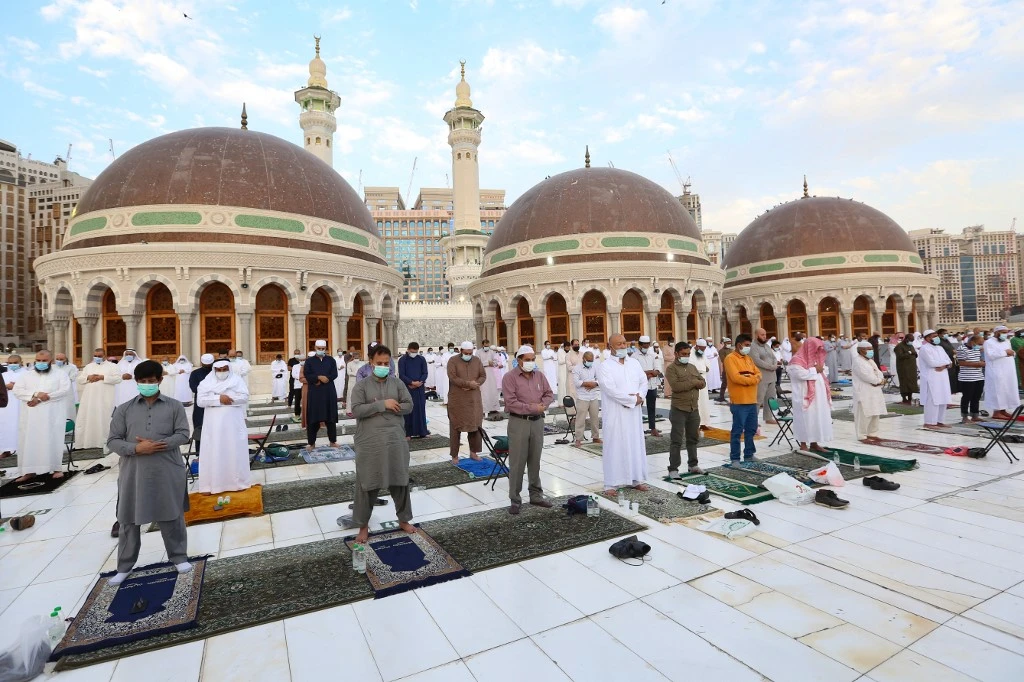 Muslims perform the Eid Al-Fitr morning prayer at the Grand Mosque in Saudi Arabia’s Makkah on May 13, 2021. (AFP)