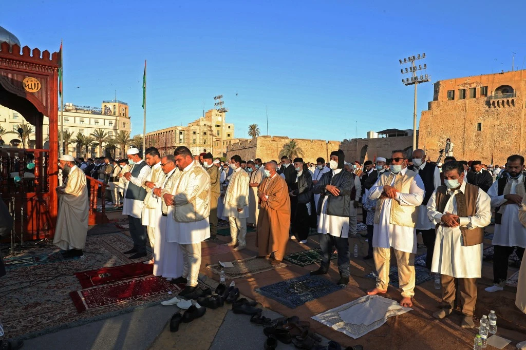 Muslims gather to perform the Eid Al-Fitr prayer at the Martyrs Square of the capital Tripoli, on May 13, 2021. (AFP)