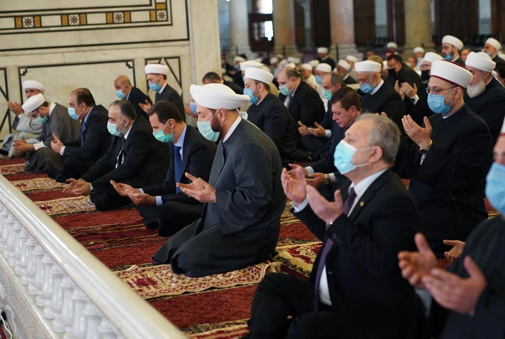 President Bashar Al-Assad performs the Eid Al-Fitr prayer at the Grand Umayyad Mosque in Damascus on May 13, 2021. (AFP)