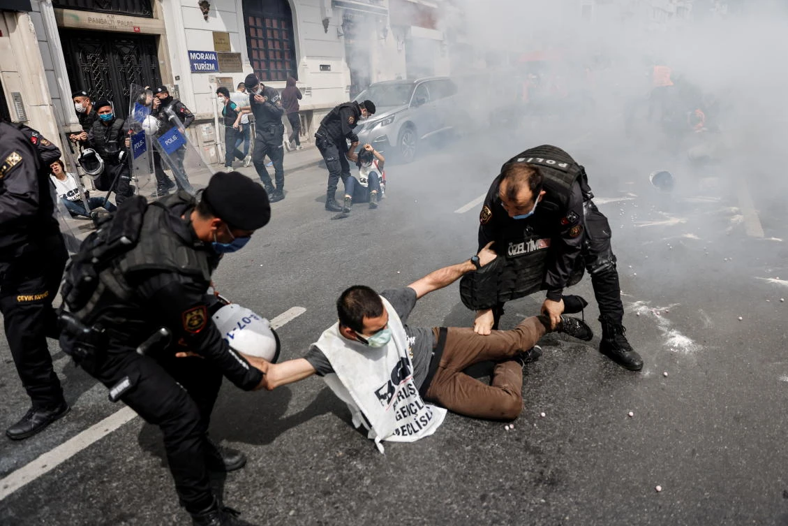 Riot police officers detain demonstrators as they attempt to defy a ban and march on Taksim Square to celebrate May Day, during a nationwide "full closure”, in Istanbul, Turkey May 1, 2021. (Reuters)