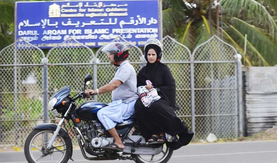 In this photo taken on April 25, 2019, Sri Lankan Muslims ride a bike along a road in Kattankudy. (AFP)