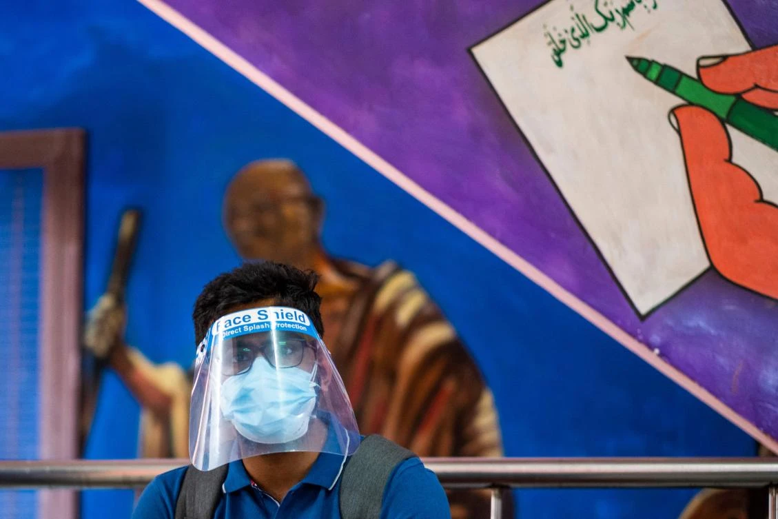 A man waits to get a COVID-19 coronavirus vaccine in a school-turned-vaccination center in New Delhi. (AFP)