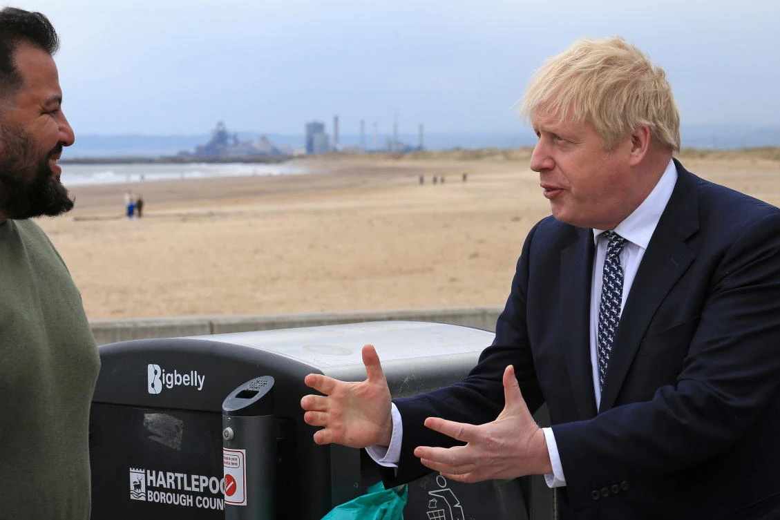 Britain's Prime Minister Boris Johnson speaks to a member of the public as he campaigns on behalf of Conservative Party candidate Jill Mortimer in Hartlepool, Britain May 3, 2021. (Reuters)