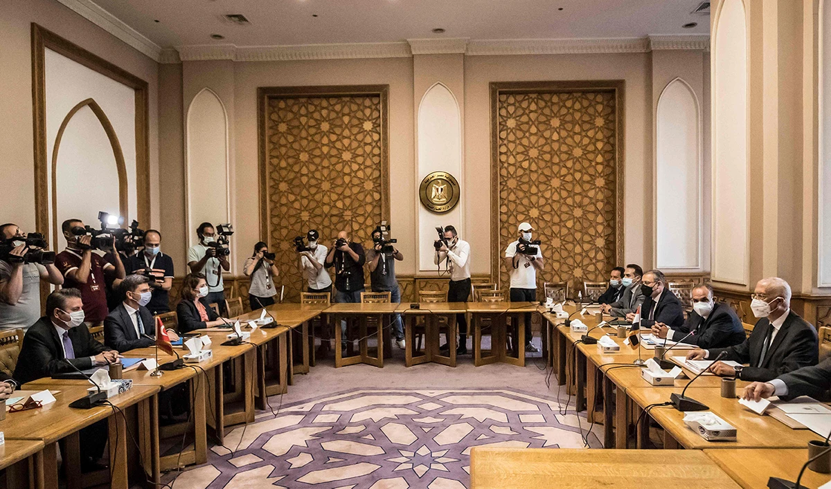Egypt's Deputy Foreign Minister Hamdi Sanad Loza (R) meets with his Turkish counterpart Sedat Onal (L) in the foreign ministry headquarters in the Egyptian capital Cairo on May 5, 2021. (AFP)