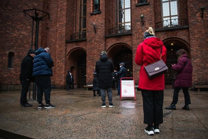 People waiting in February to enter Stockholm’s City Hall for COVID-19 vaccination centre in Sweden that announced Thursday it had recorded over one million cases. (AFP)