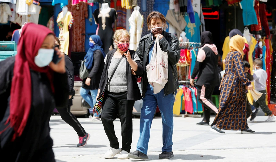 People wearing protective face masks walk in Tunis, amid the coronavirus disease (COVID-19) outbreak, Tunisia, April 29, 2021. (REUTERS)