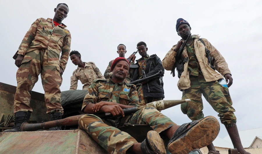 Somali opposition soldiers pose for a photograph in Mogadishu as they move to their barracks after reaching an agreement with the prime minister. (Reuters)