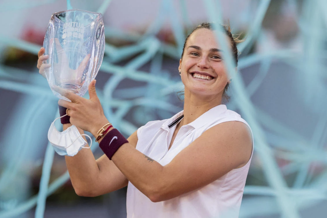 Aryna Sabalenka of Belarus holds a trophy after winning the women's final match against Australia's Ashleigh Barty at the Mutua Madrid Open tennis tournament on May 8, 2021. (AP Photo/Bernat Armangue)