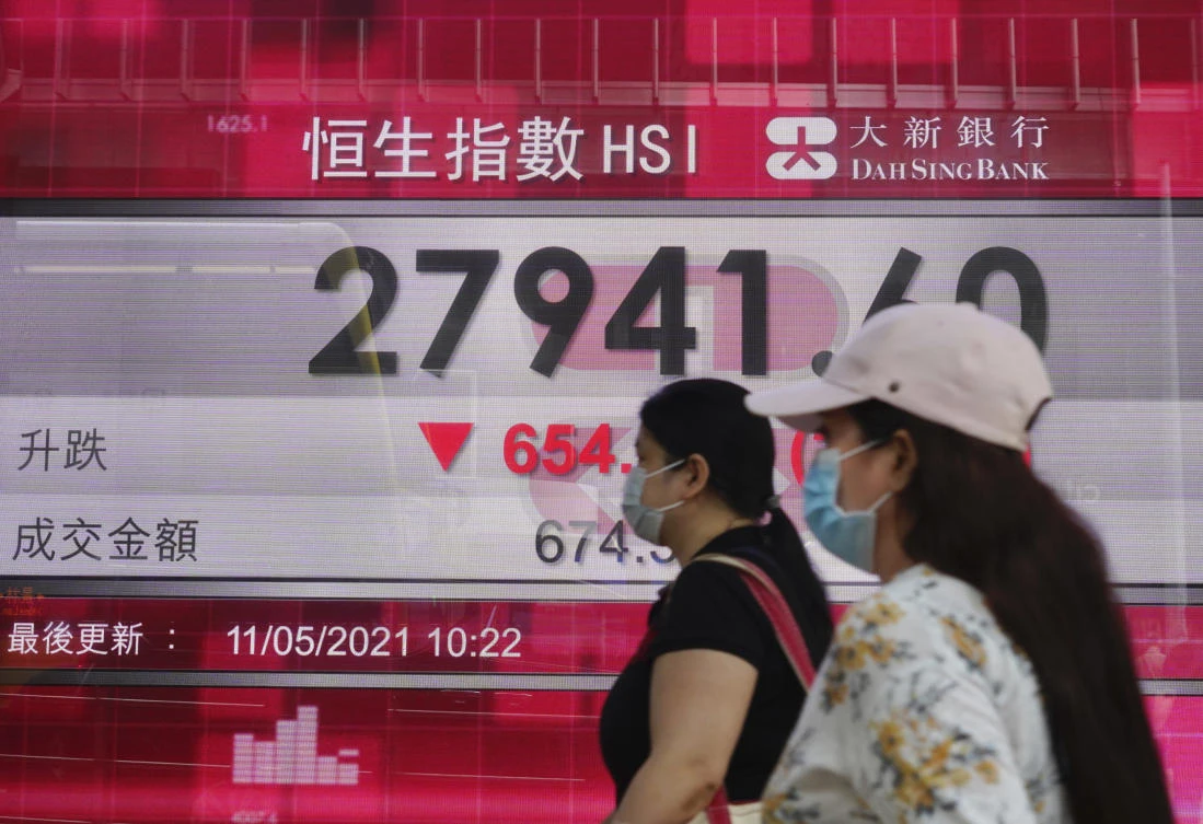 People walk past the Hong Kong Stock Exchange. Shares dropped Tuesday in Asia. (AP)