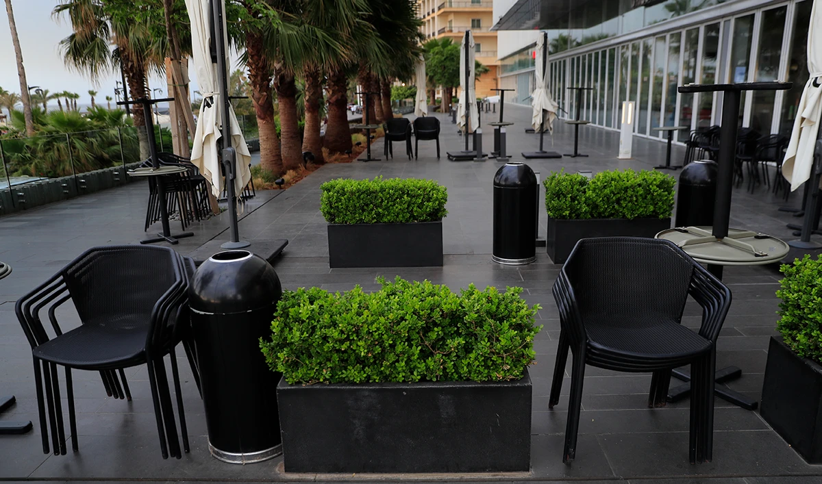 Assembled tables and chairs are empty at closed coffee shops at Beirut's waterfront promenade, during the first day of Eid Al-Fitr holiday, in Beirut, Lebanon, Thursday, May 13, 2021. (AP)