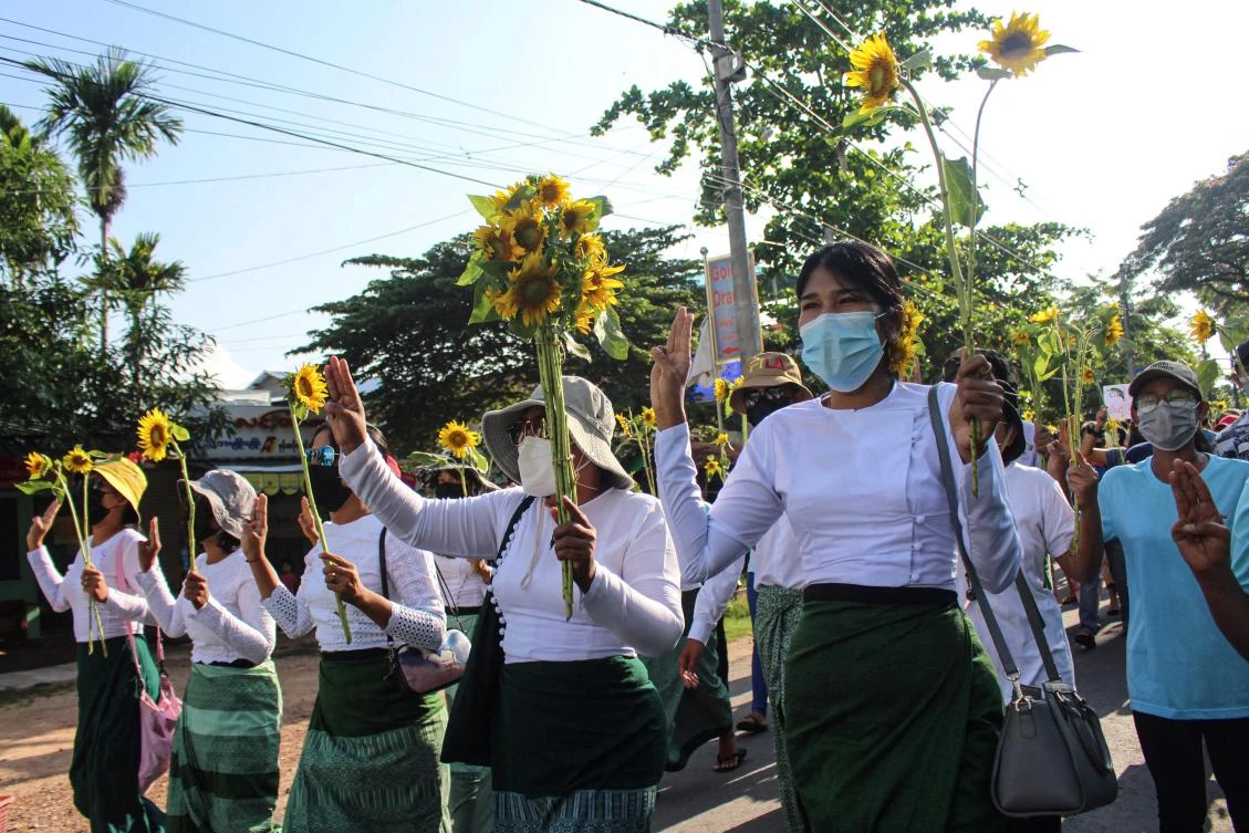 Protesters hold sunflowers during a demonstration against the military coup in Dawei, Myanmar. (Dawei Watch via AFP)