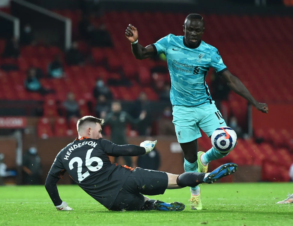 Manchester United's Dean Henderson in action with Liverpool's Sadio Mane. While leaving the field, Mane declined to shake hands with Jürgen Klopp, who said he plans to talk with the Senegal winger.(REUTERS)