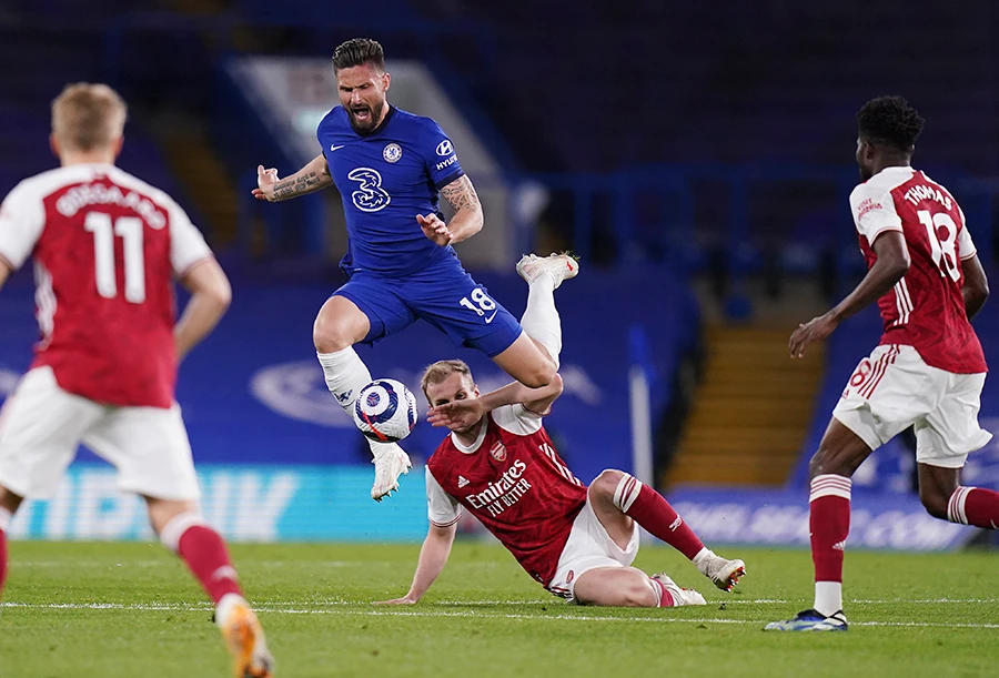 Chelsea’s Olivier Giroud, top, challenges for the ball with Arsenal’s Rob Holding during their English Premier League match on Wednesday. (AP)