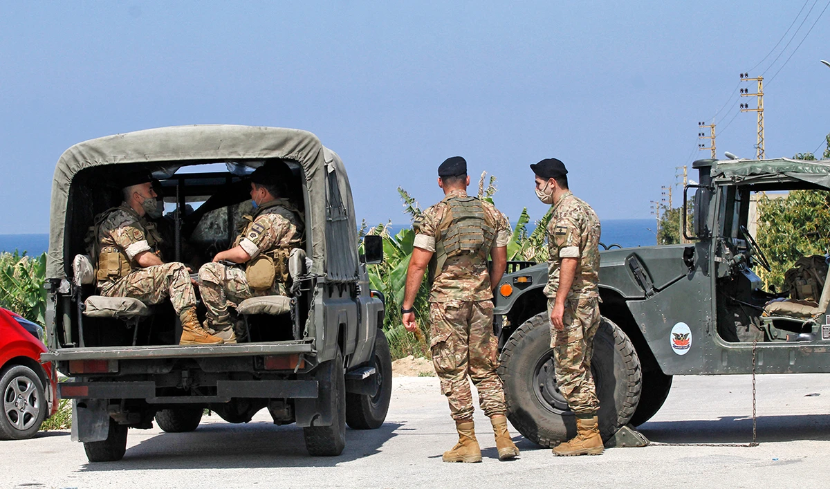 Lebanese soldiers stand guard in the town of Qlaile. Three rockets were fired from southern Lebanon toward Israel, a military source said. (AFP)