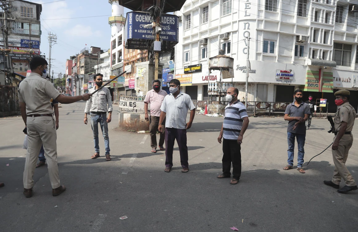 Above, police officials punish the people who break the rule of restrictions for COVID-19 in Gauhati, India. (AP)
