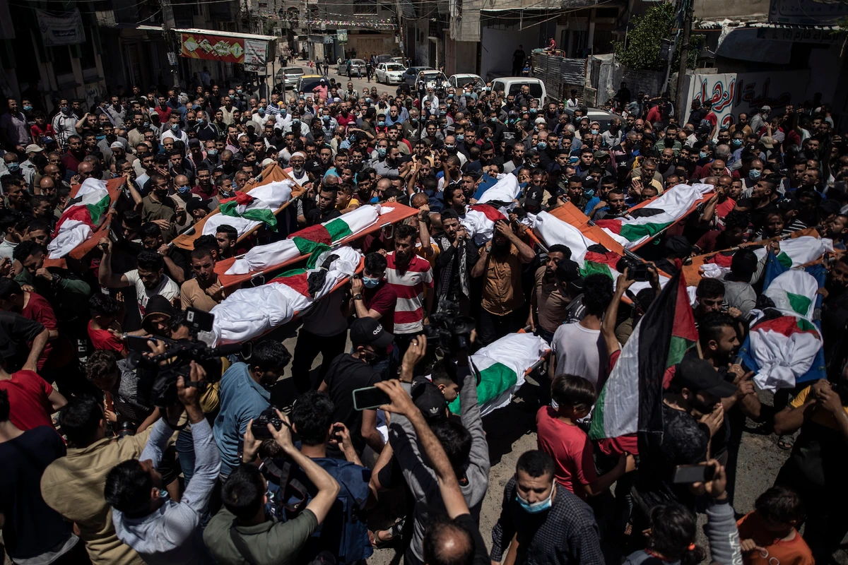 Palestinians attend the funeral of two women and eight children of the Abu Hatab family in Gaza City, who were killed by an Israeli air strike, Saturday, May 15, 2021. (AP)