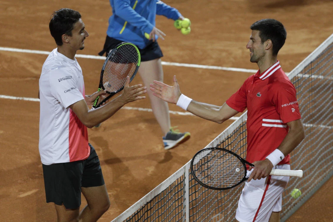 Serbia's Novak Djokovic, right, greets Italy's Lorenzo Sonego after their semi-final match at the Italian Open tennis tournament in Rome on May 15, 2021. (AP Photo/Gregorio Borgia)