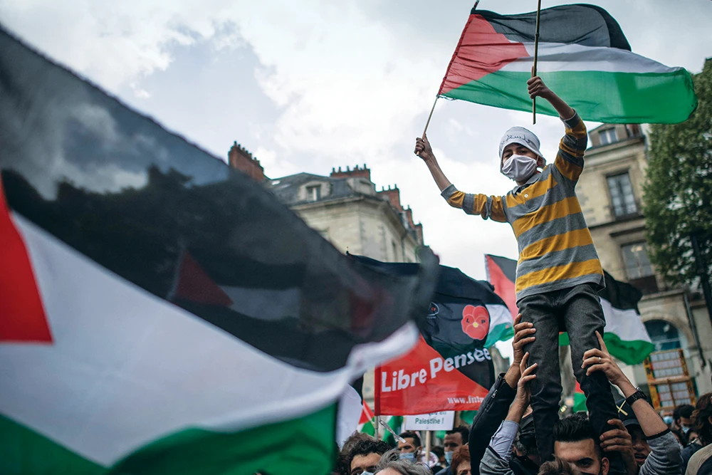 A young activist in Nantes, western France, holds a Palestinian flag during Saturday’s demonstration in support of Gaza’s resistance against Israel. (AFP)