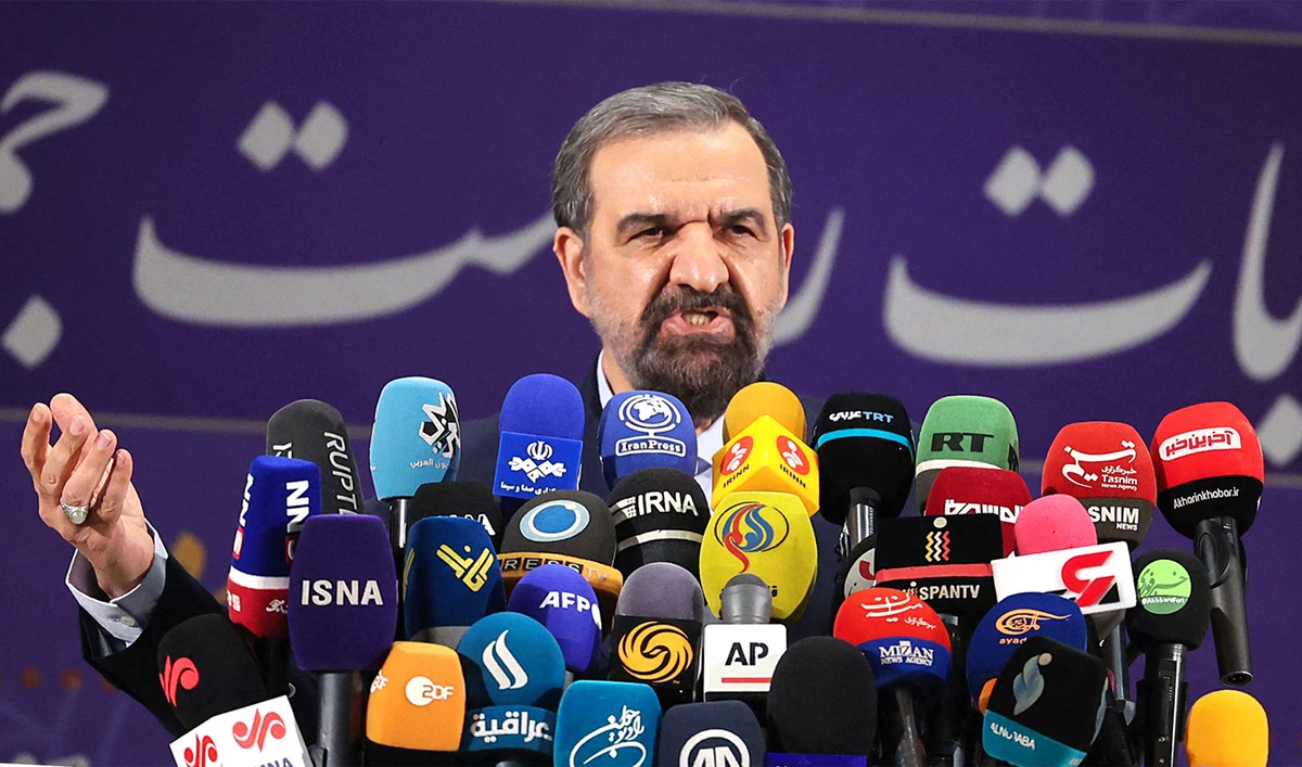 Iranian former chief of the Revolutionary Guards Mohsen Rezai talks to the media after registering his candidacy for the June presidential elections. (AFP)