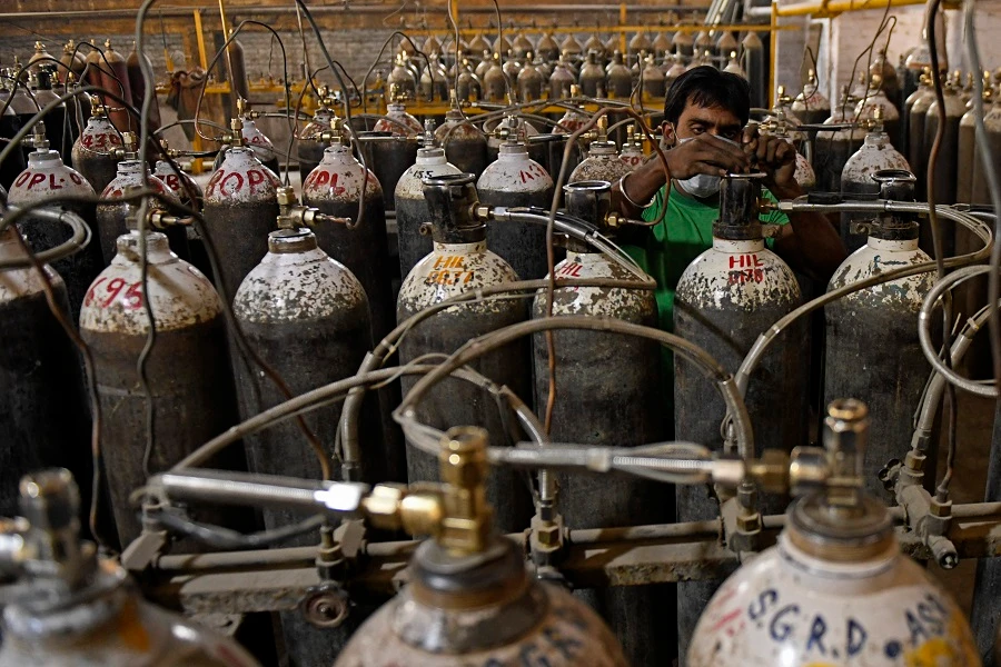 Workers are seen sorting oxygen cylinders that are being used for Covid-19 coronavirus patients before dispatching them to hospitals at a facility on the outskirts of Amritsar on April 28, 2021. (File/AFP)