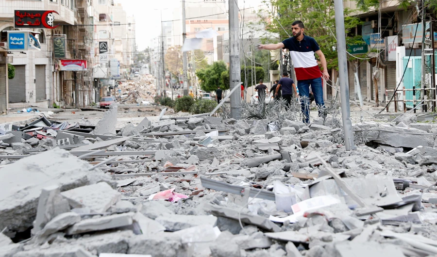 A man inspects the rubble of destroyed commercial building and Gaza health care clinic following an Israeli airstrike on the upper floors of a commercial building in Gaza City, on Monday, May 17, 2021. (AP)
