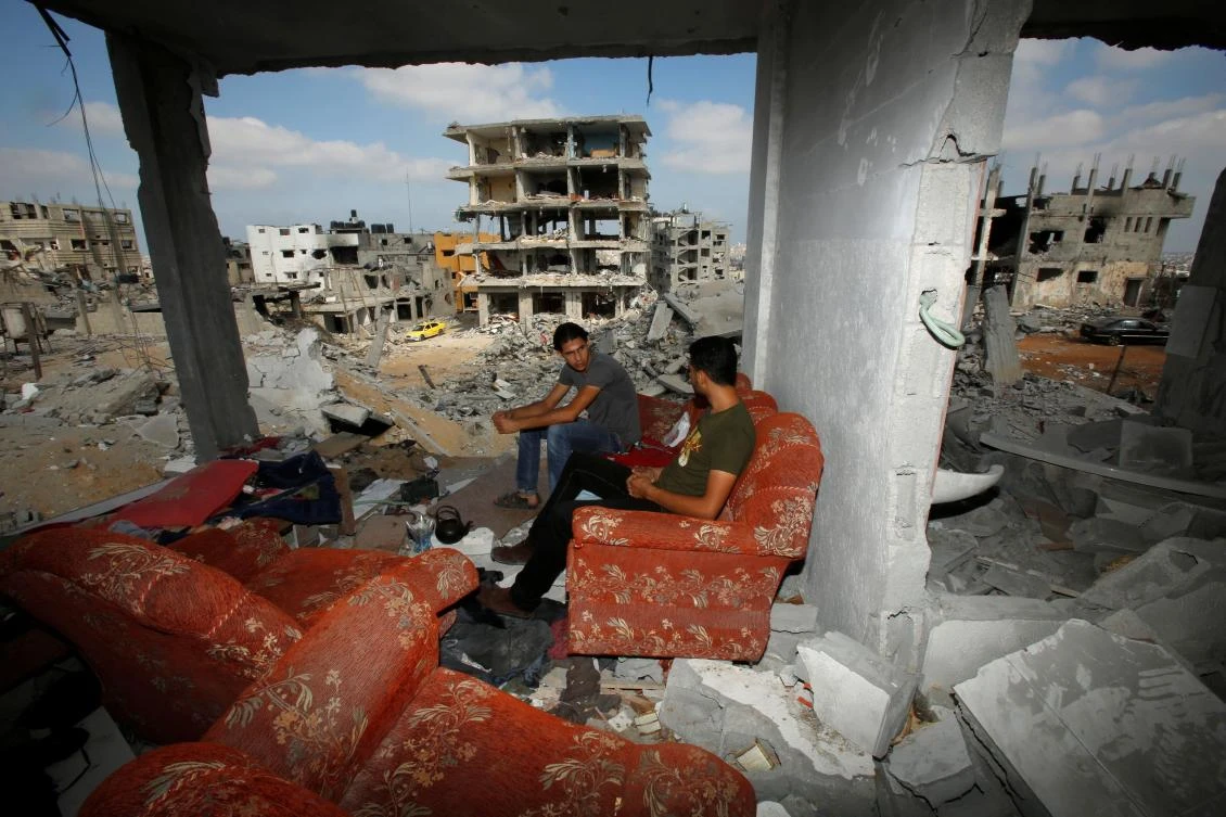 Palestinians sit on a couch as they return to the remains of their house, which witnesses said was destroyed in an Israeli offensive, in the east of Gaza City August 27, 2014. (Reuters)