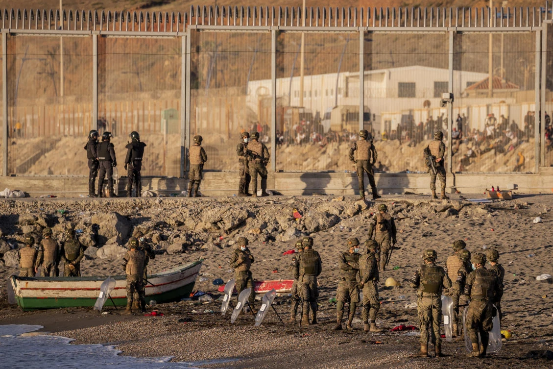 Spanish security forces guard the Spanish enclave of Ceuta, near the border of Morocco and Spain, Wednesday, May 19, 2021. (AP Photo/Bernat Armangue)