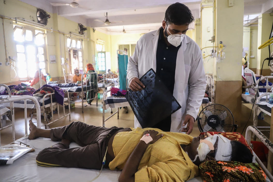A doctor assists a Covid-19 coronavirus patient with Black Fungus, a deadly and rare fungal infection, as he receives treatments at the NSCB hospital in Jabalpur, on May 20, 2021. (File/AFP)