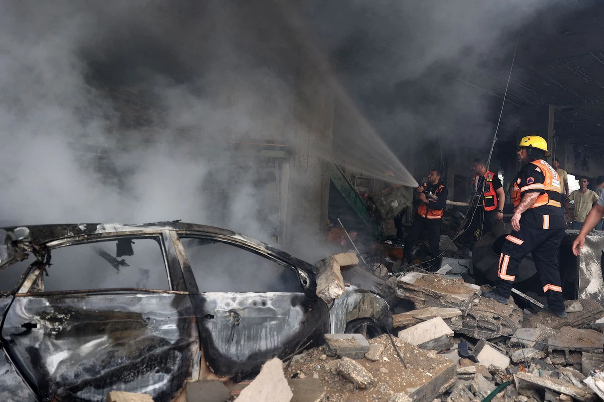 Palestinian firefighters battle flames following an Israeli airstrike in Gaza City May 20, 2021. (AFP)
