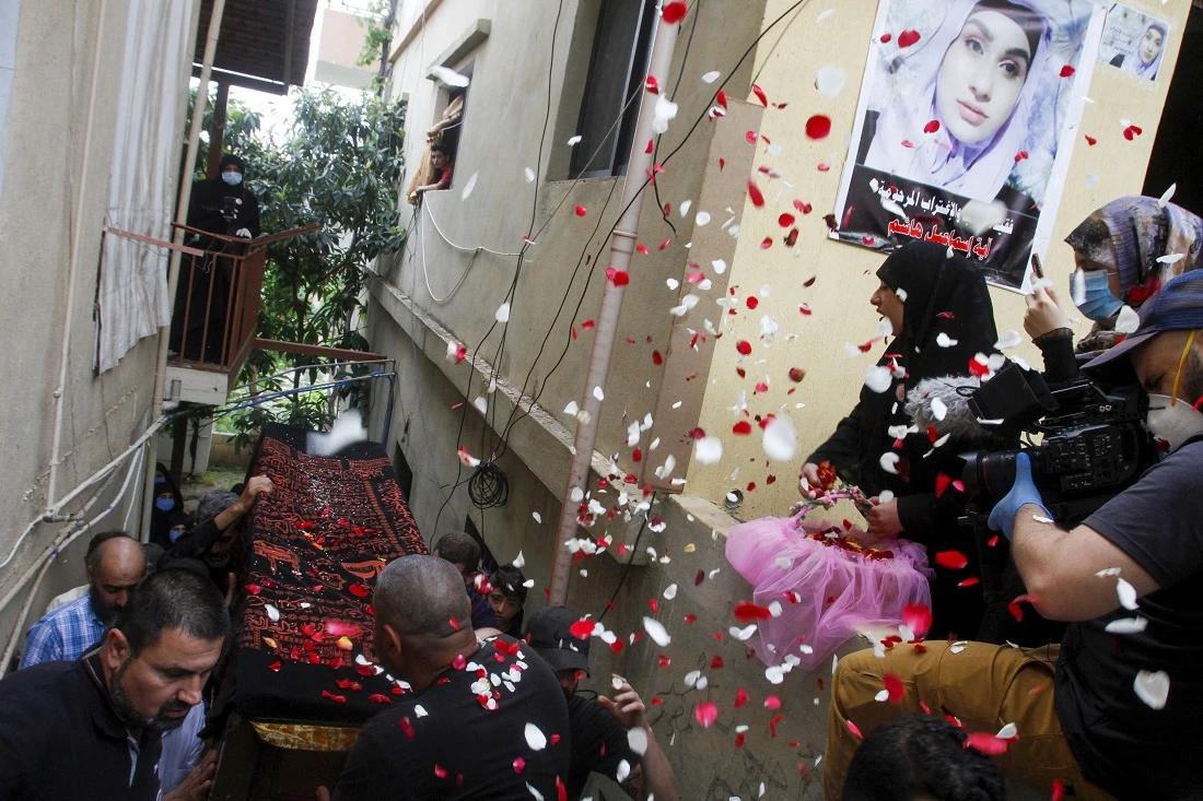 Mourners carry the casket of Aya Hachem, a 19-year-old law student who was killed in a shooting in the UK town of Blackburn on May 17. (Mahmoud Zayyat/AFP)