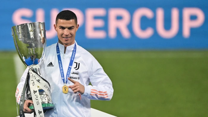 Juventus’ Portuguese forward Cristiano Ronaldo poses with the winners’ trophy after the Italian Super Cup. (AFP/File Photo)