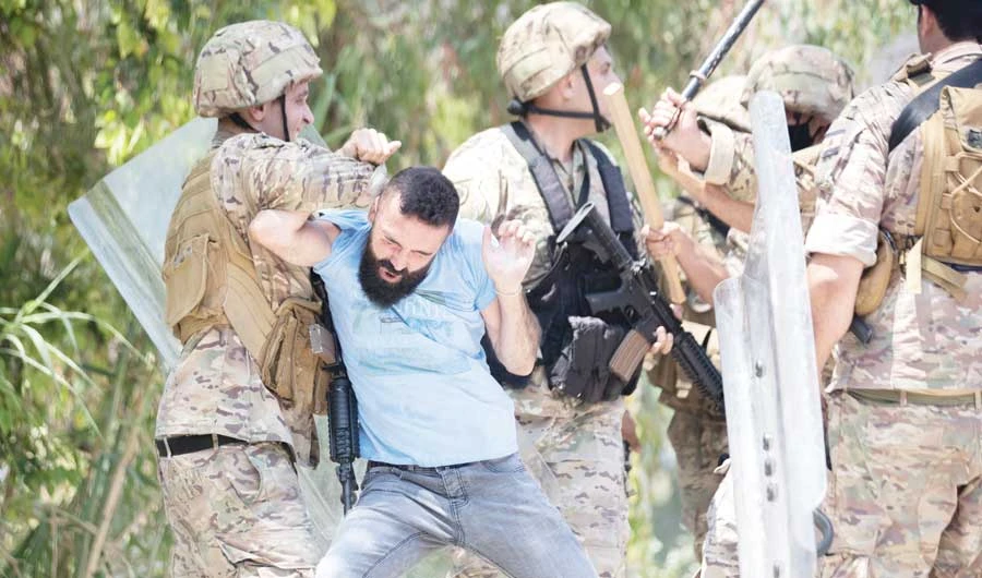 Soldiers scuffle with angry Lebanese men who attacked buses carrying Syrians to their embassy near Beirut to vote in Syrian presidential election. (File/AP)