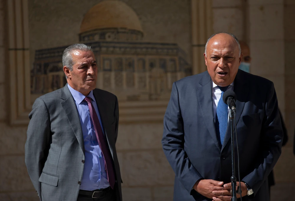 Egyptian FM Sameh Shoukry, right, with Chairman of the Palestinian Civil Affairs Commission Hussein Al-Sheikh, after a meeting with Palestinian President Mahmoud Abbas, Ramallah, May 24, 2021. (AP Photo)