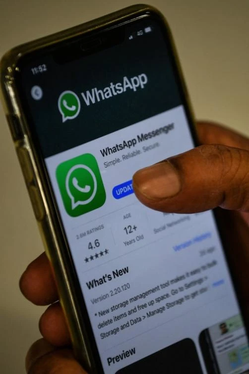 A user updates Facebook's WhatsApp application on his mobile phone in Mumbai (File/AFP)..