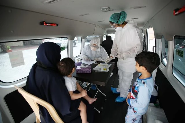 Doctors check a traveller in their designated residential area to check on residents who returned from Iran if anyone is infected with the novel coronavirus, at Isa Town Health Center, south of Manama, Bahrain, March 2, 2020. (Reuters)